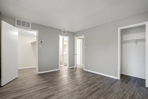 an empty living room with white walls and wood flooring